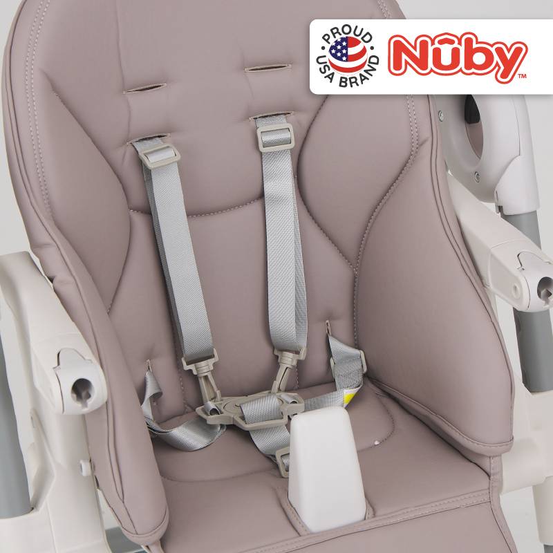 Astra Family The nuby high chair has a grey seat and white straps.